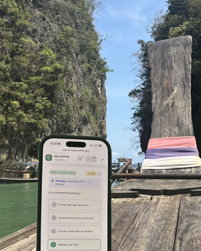 The MarvelPrep app on a phone on a longtail boat between limestone cliffs