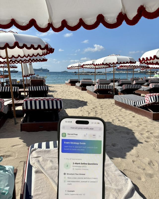 The MarvelPrep app on a phone among striped beach-club umbrellas